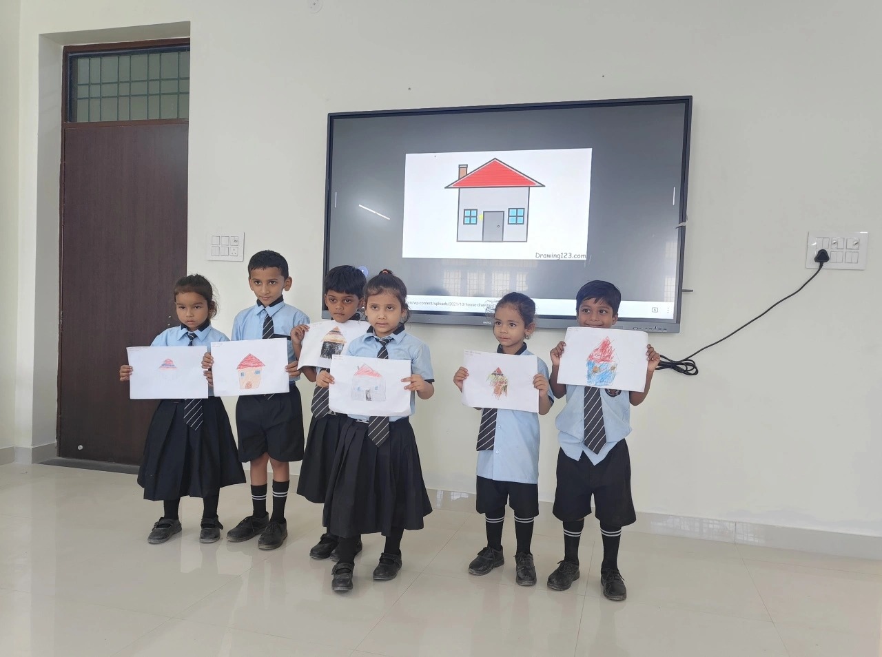 Students showcasing artwork in classroom